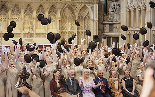 Norland Nannies graduating throwing hats in the air