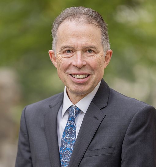 Board member Richard Maccabee smiling to camera in outdoor headshot