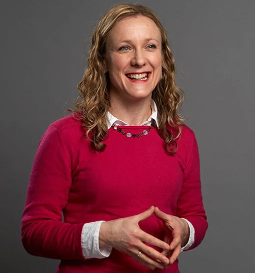 Dr Caron Carter headshot, smiling in a professional background