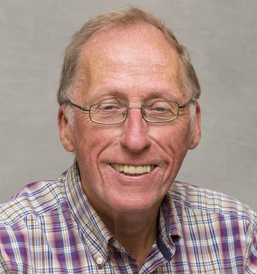 Emeritus Professor Peter Moss headshot smiling to camera